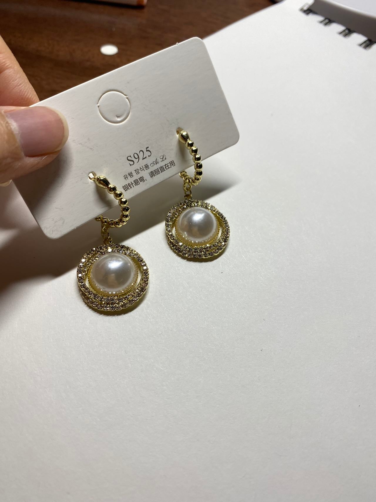 Synthetic pearl with hoop earrings